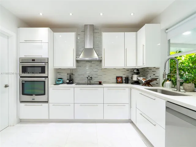 a kitchen with stainless steel appliances kitchen island granite countertop a stove a sink and a microwave