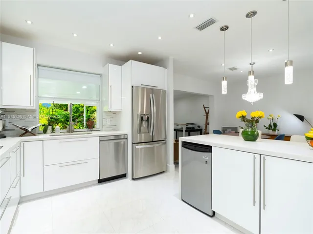 a kitchen with a sink stainless steel appliances and cabinets