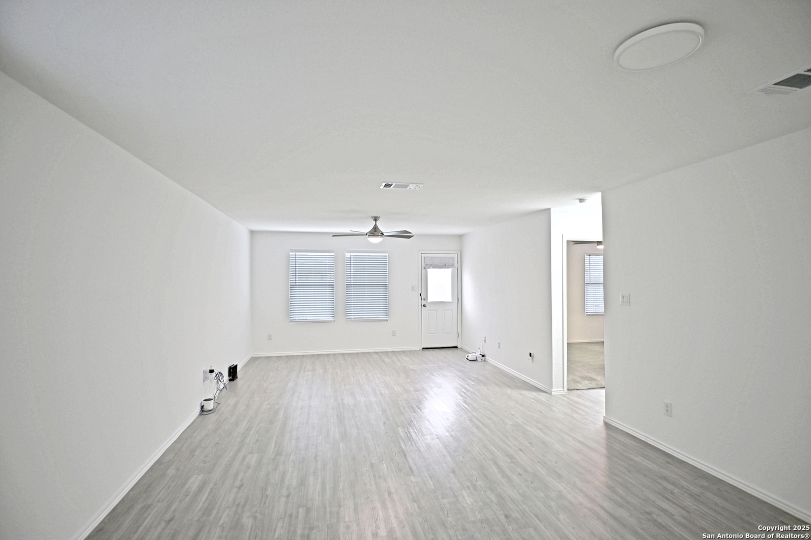 5925 San Geronimo Seguin, TX 78155 - Photo 13 of 29 an empty room with wooden floor and windows