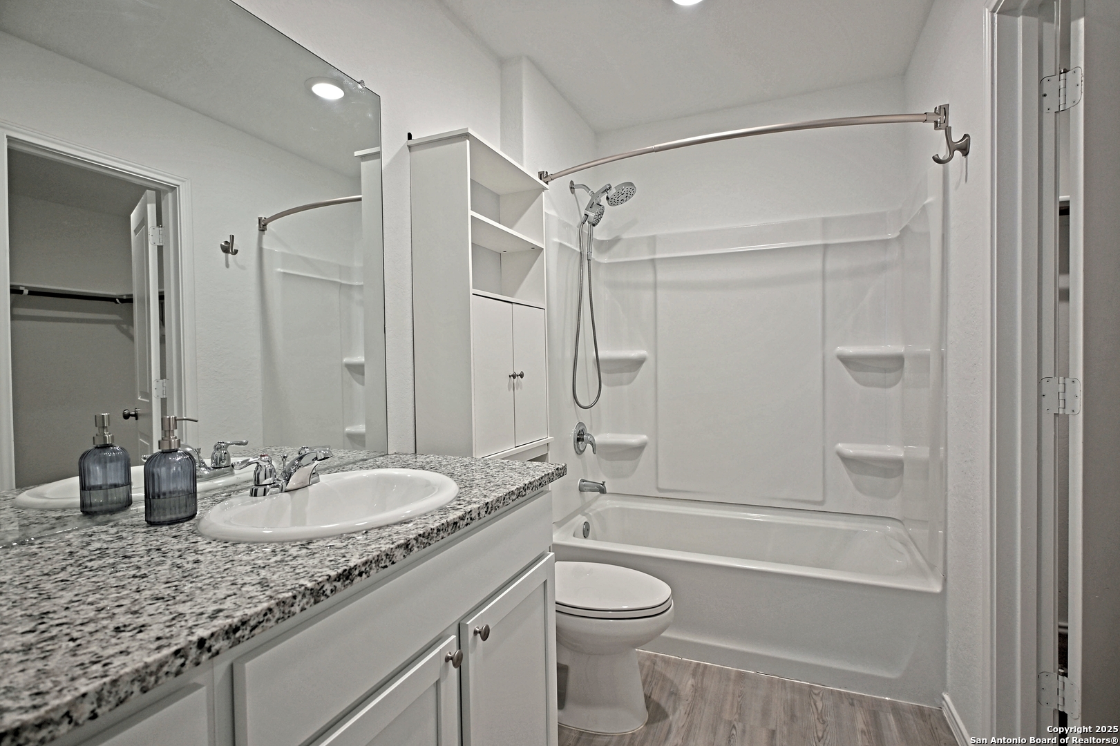 5925 San Geronimo Seguin, TX 78155 - Photo 17 of 29 a bathroom with a granite countertop sink toilet mirror and shower