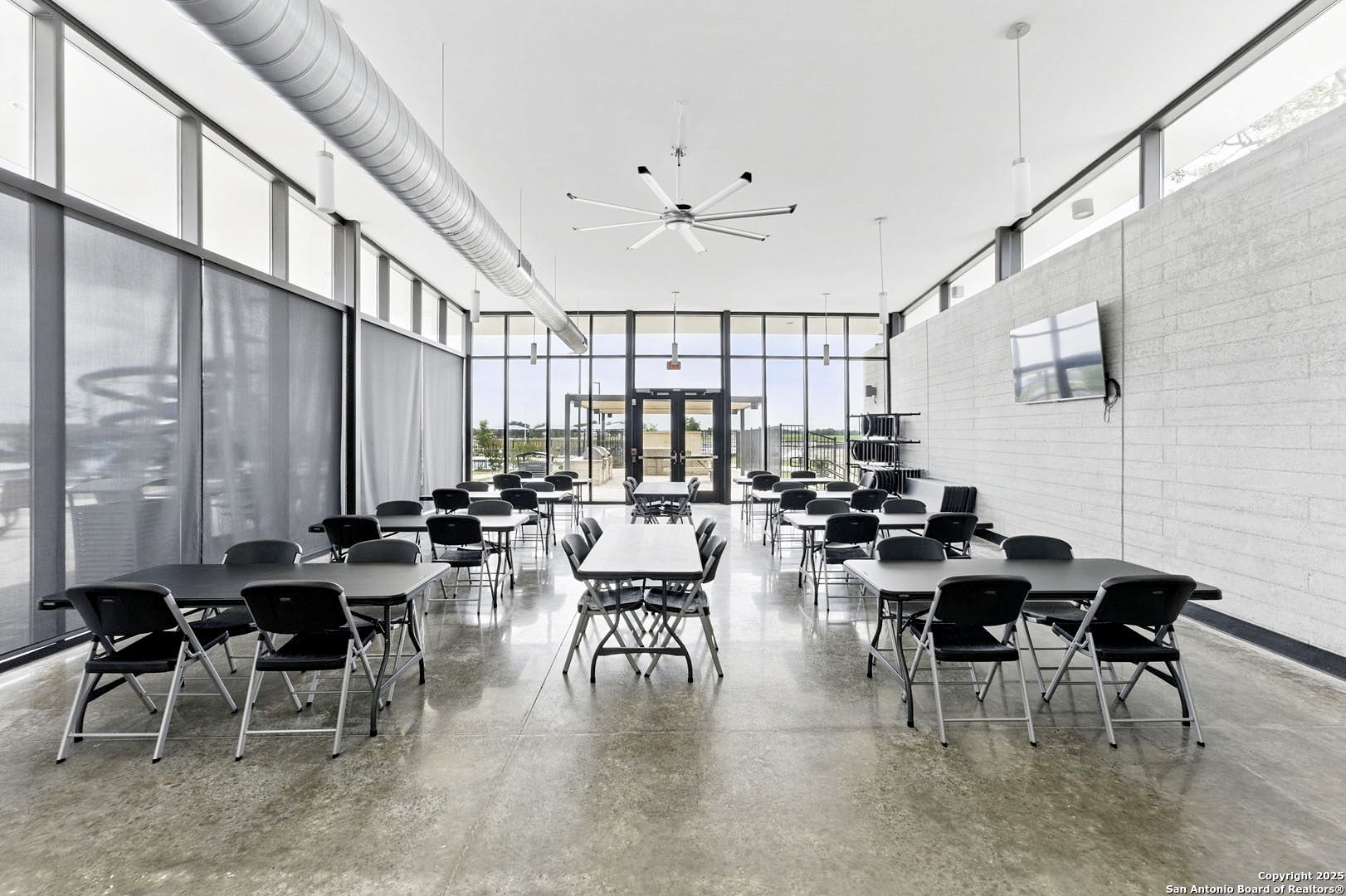 5925 San Geronimo Seguin, TX 78155 - Photo 28 of 29 a room with lots of tables a large window and chairs