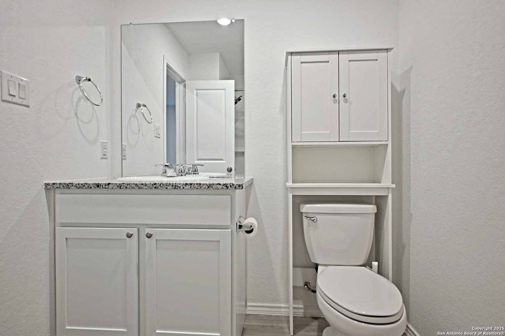 5925 San Geronimo Seguin, TX 78155 - Photo 7 of 29 a bathroom with a toilet sink vanity and mirror