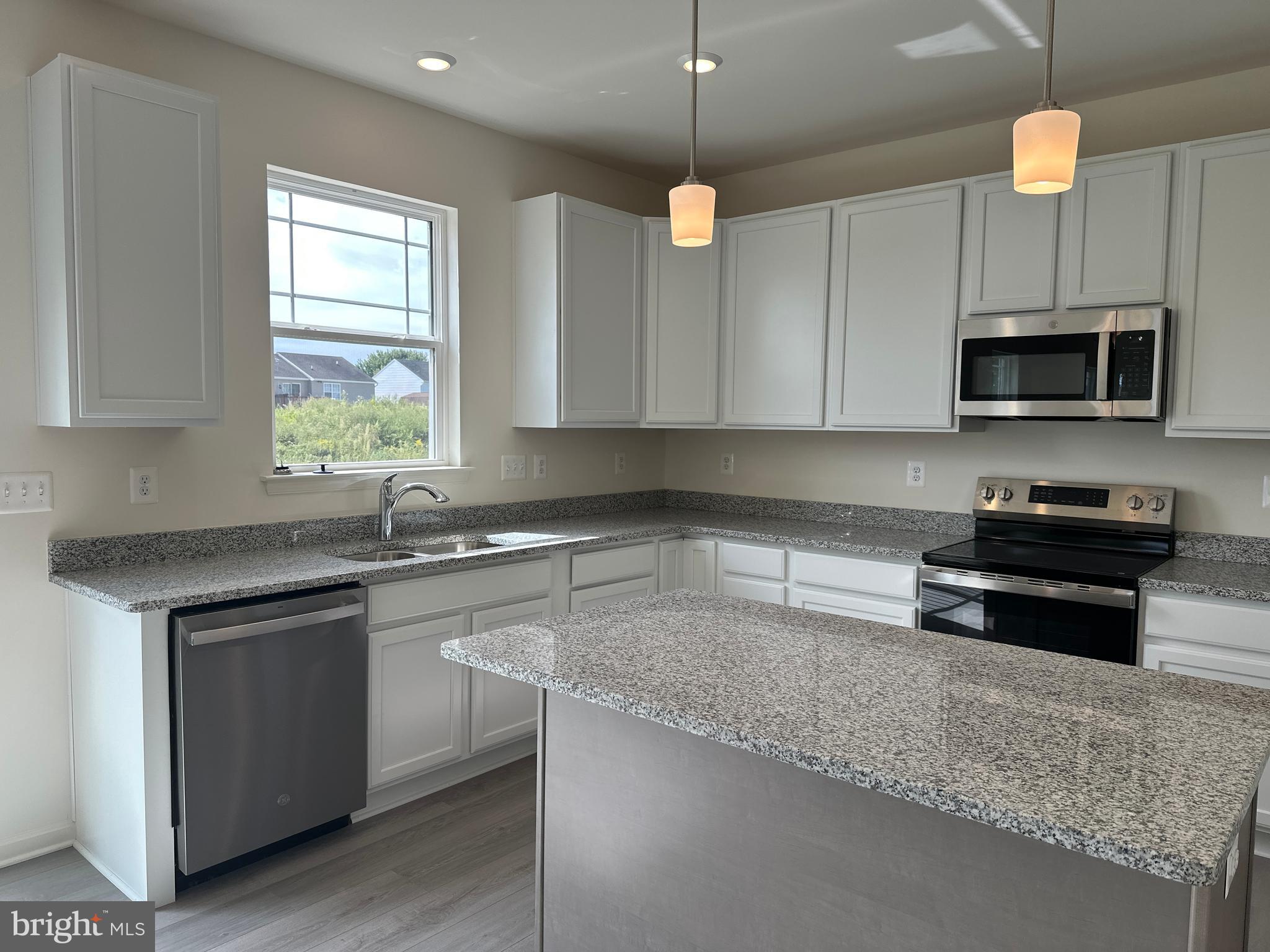 60 Chase Circle Elkton, MD 21921 - Photo 12 of 48 a kitchen with kitchen island granite countertop a sink cabinets and window