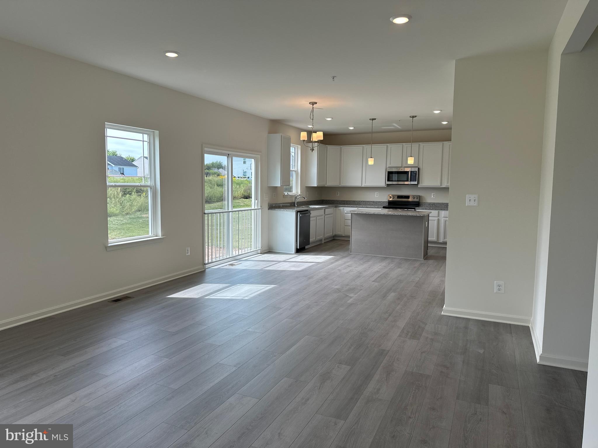 60 Chase Circle Elkton, MD 21921 - Photo 18 of 48 a open kitchen with kitchen island a sink dishwasher stove and oven with wooden floor