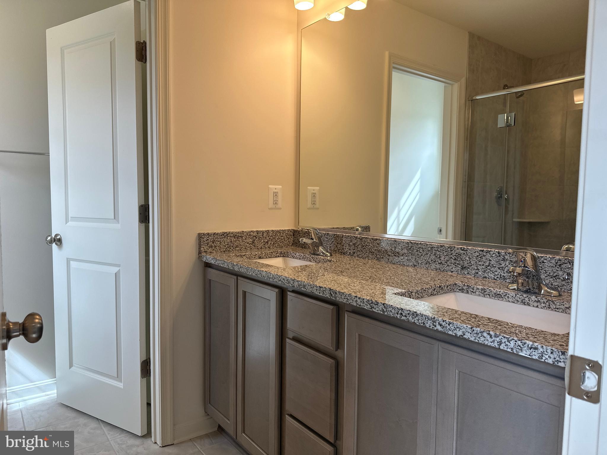 60 Chase Circle Elkton, MD 21921 - Photo 25 of 48 a bathroom with a granite countertop sink and a mirror