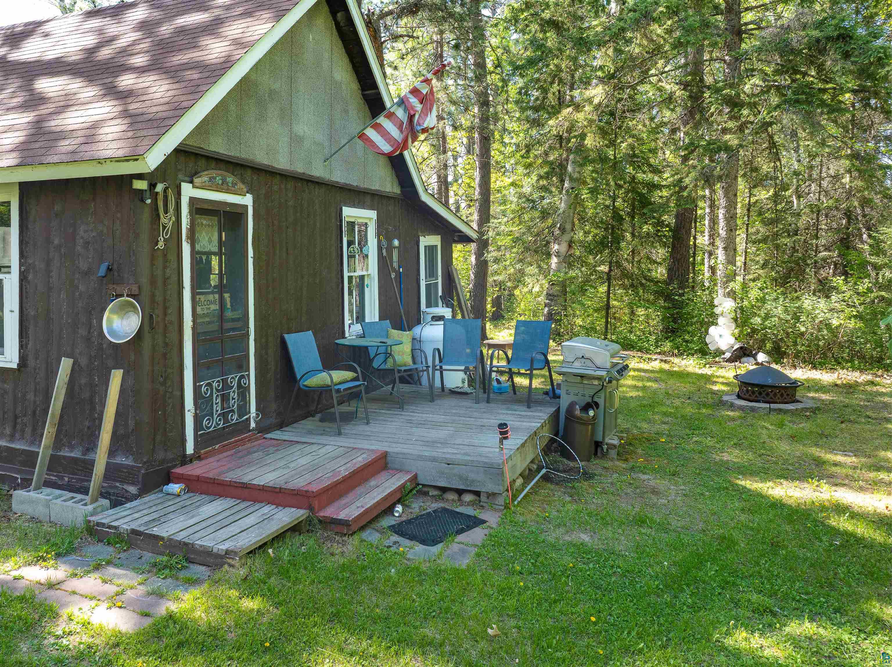 9064 Peppard Road Britt, MN 55710 - Photo 10 of 40 Exterior features brown wood siding and a covered deck
