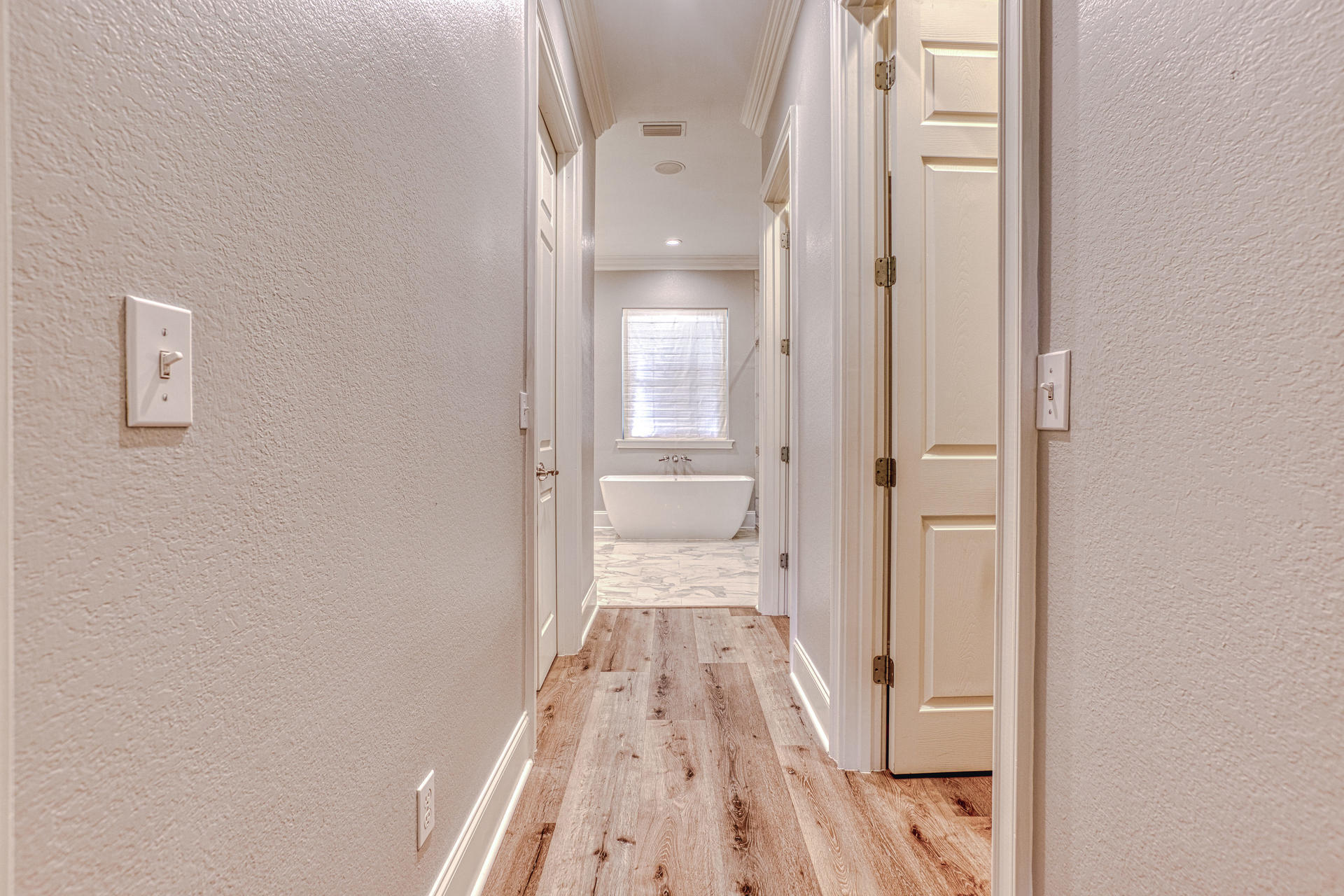 160 Grand Flora Way Santa Rosa Beach, FL 32459 - Photo 13 of 51 a view of a hallway with wooden floor and a bathroom