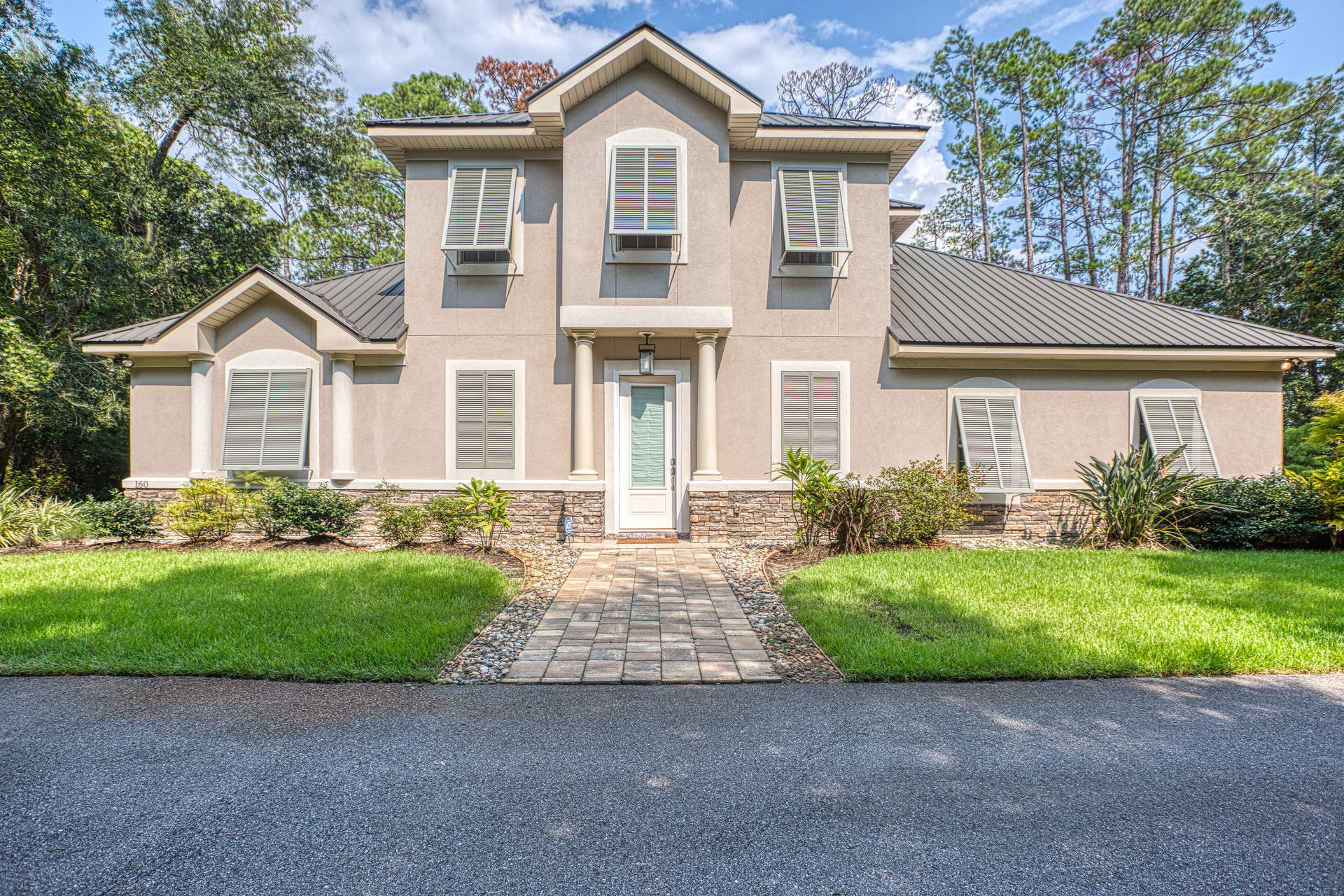 160 Grand Flora Way Santa Rosa Beach, FL 32459 - Photo 3 of 51 a front view of a house with a garden and yard