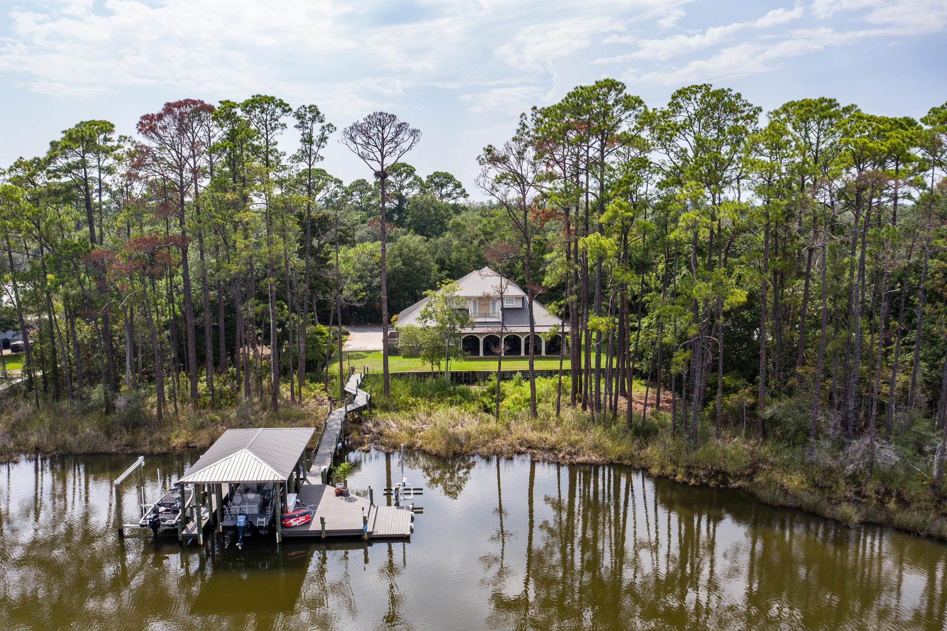 160 Grand Flora Way Santa Rosa Beach, FL 32459 - Photo 4 of 51 a view of a lake with a house in the background