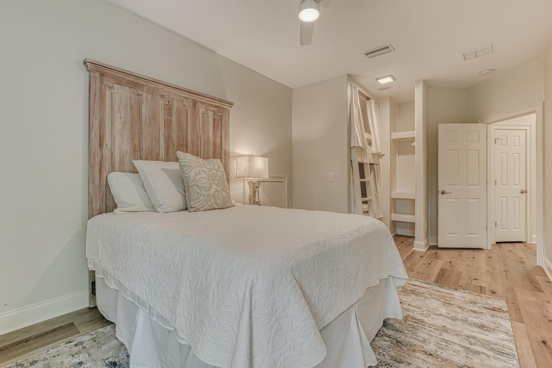 160 Grand Flora Way Santa Rosa Beach, FL 32459 - Photo 34 of 51 a spacious bedroom with a bed and a walk in closet