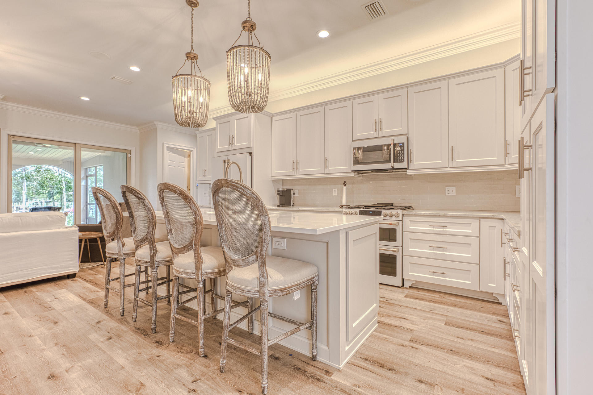160 Grand Flora Way Santa Rosa Beach, FL 32459 - Photo 5 of 51 a kitchen with cabinets appliances and a dining table