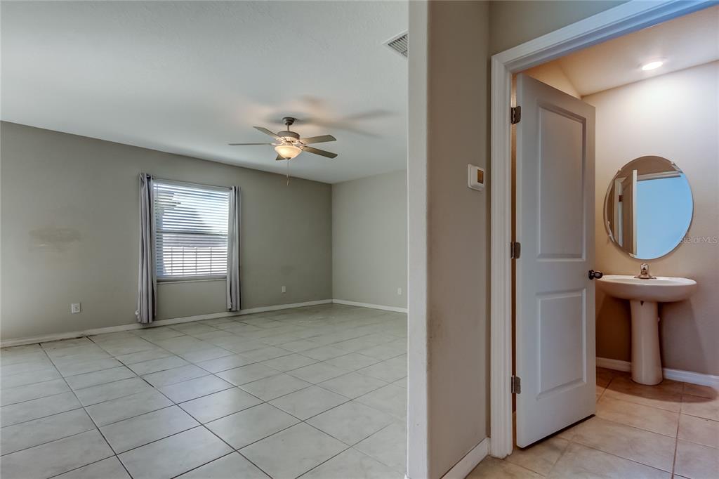 6362 Spider Lily Way New Port Richey, FL 34653 - Photo 14 of 47 an empty room with mirror and fan