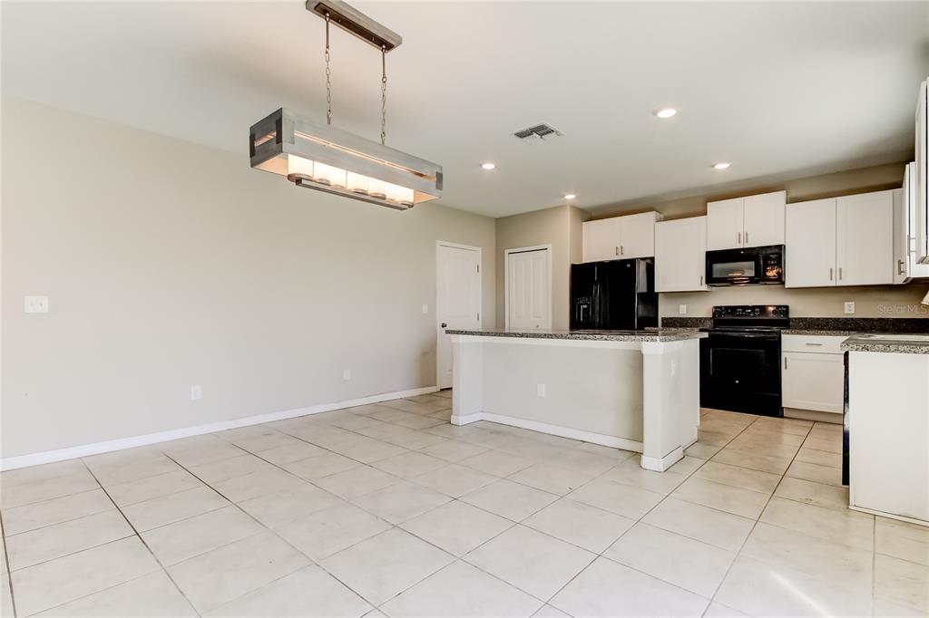 6362 Spider Lily Way New Port Richey, FL 34653 - Photo 17 of 47 a large kitchen with cabinets