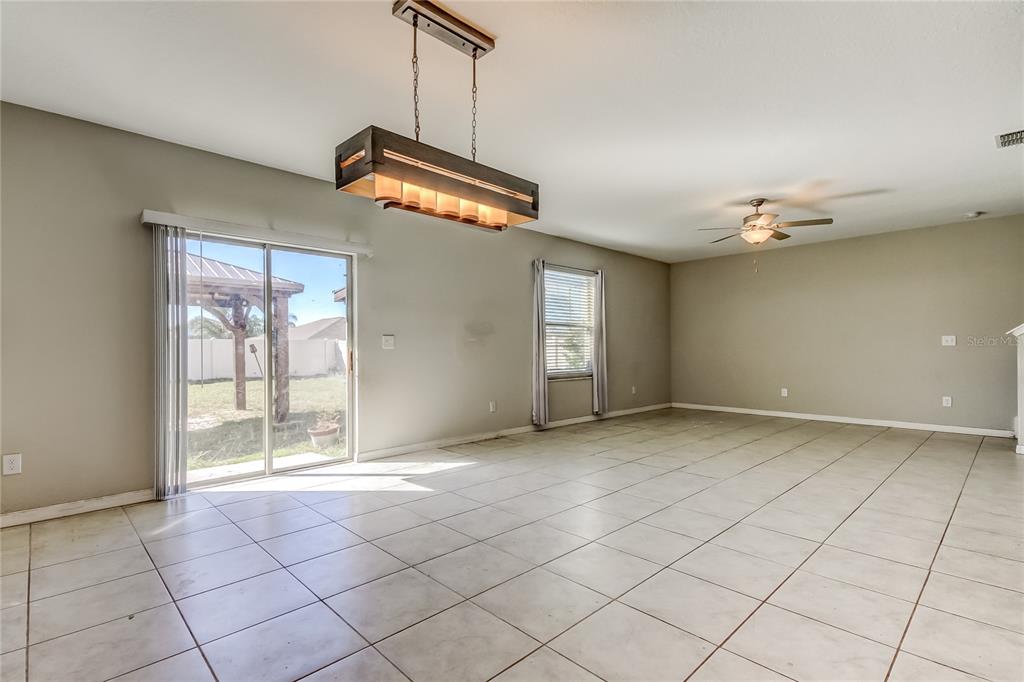 6362 Spider Lily Way New Port Richey, FL 34653 - Photo 22 of 47 a view of an empty room with window and chandelier fan