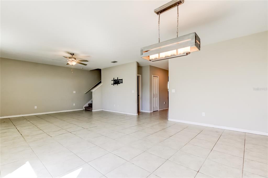 6362 Spider Lily Way New Port Richey, FL 34653 - Photo 23 of 47 an empty room with a ceiling fan and entryway