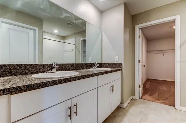a bathroom with a glass shower door