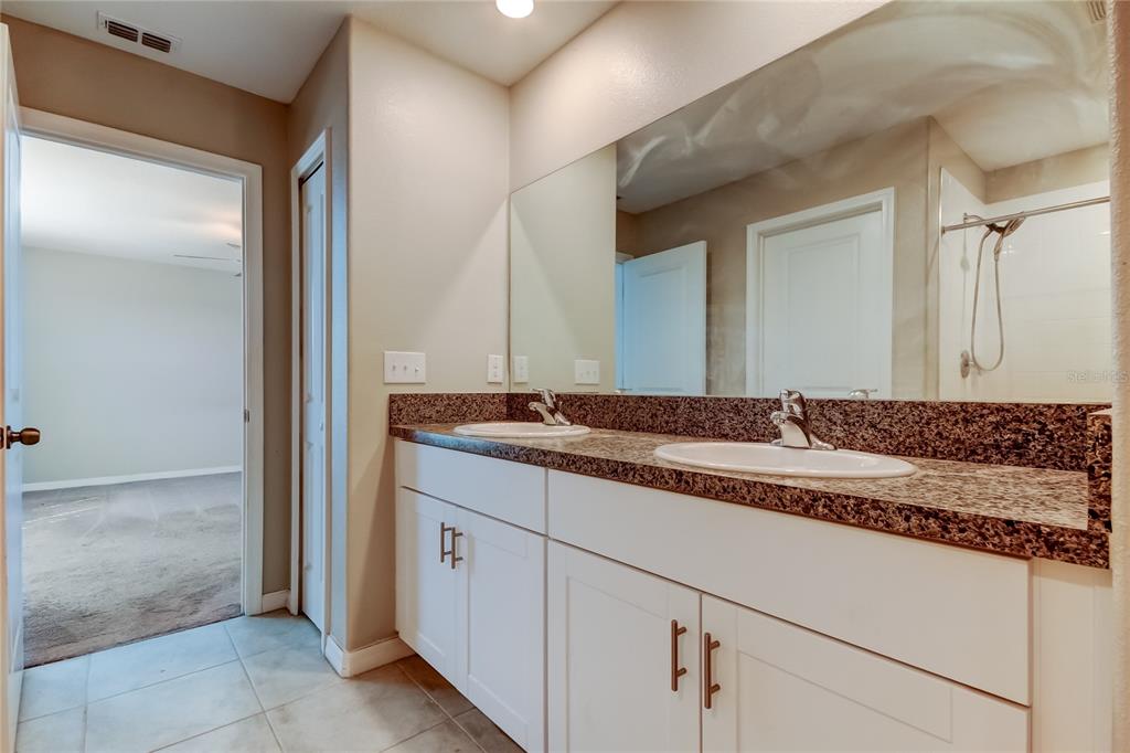 6362 Spider Lily Way New Port Richey, FL 34653 - Photo 33 of 47 a bathroom with a sink and a mirror