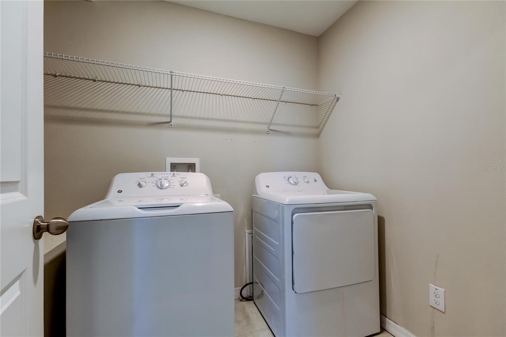6362 Spider Lily Way New Port Richey, FL 34653 - Photo 35 of 47 a utility room with dryer and washer