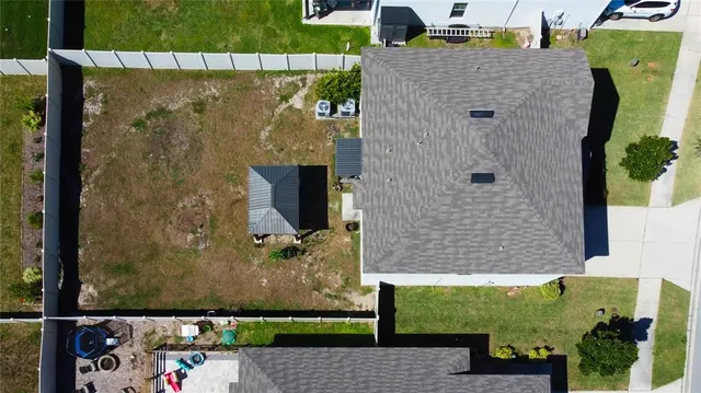 a view of a room with a chandelier fan and glass door