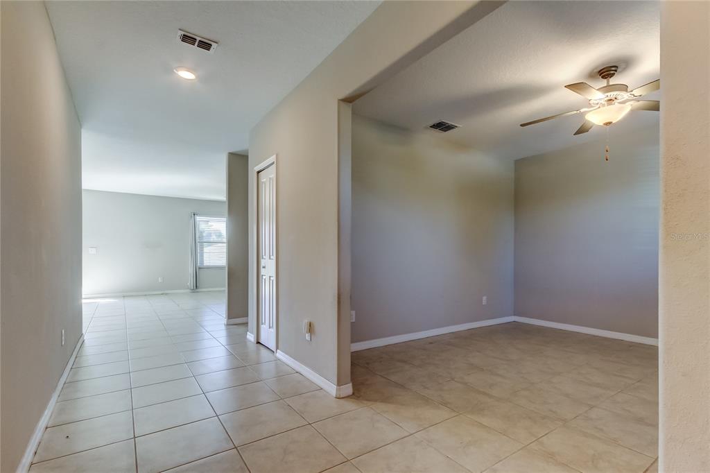 6362 Spider Lily Way New Port Richey, FL 34653 - Photo 9 of 47 a view of a room with a chandelier fan and glass door