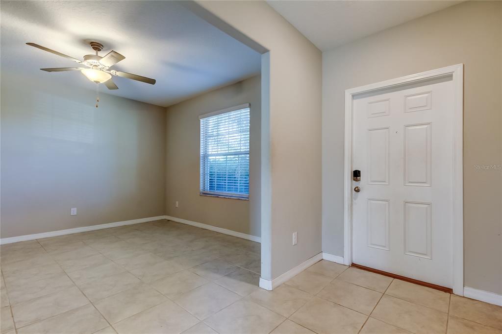 6362 Spider Lily Way New Port Richey, FL 34653 - Photo 10 of 47 an empty room with windows and fan