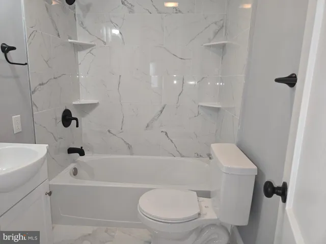 a white toilet sitting next to a bath tub shower