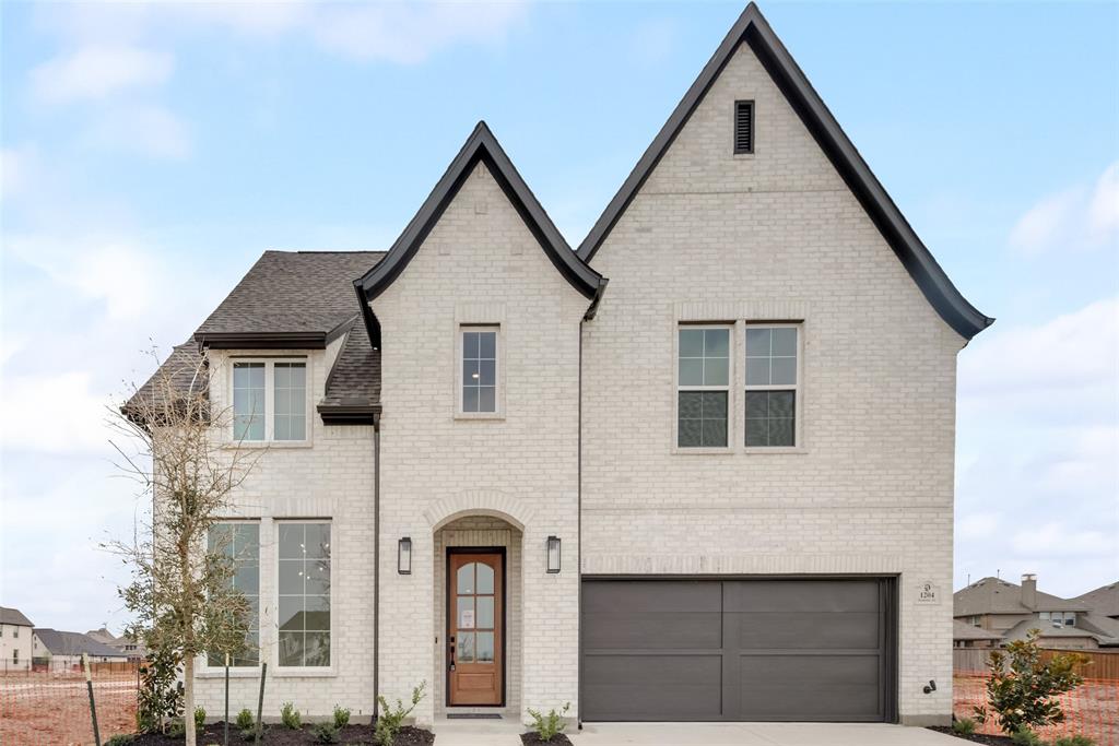a front view of a house with garage