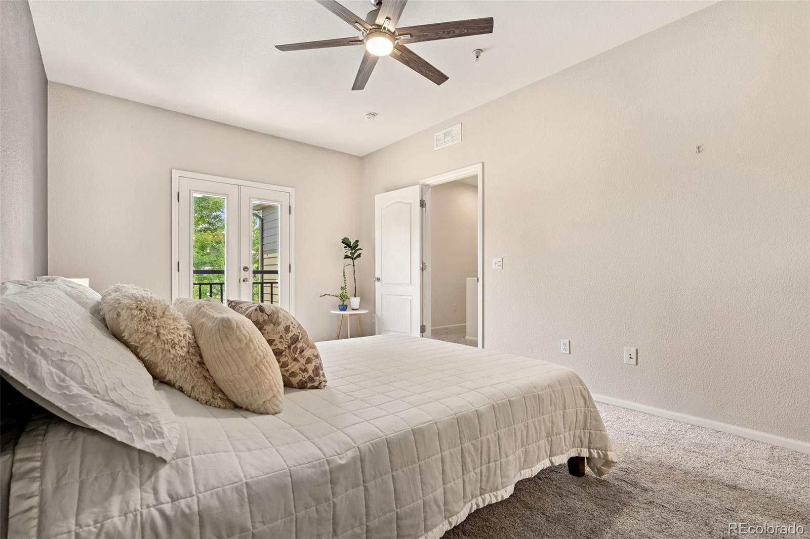 7140 Simms Street, Unit 102 Arvada, CO 80004 - Photo 17 of 34 a bedroom with a bed and window