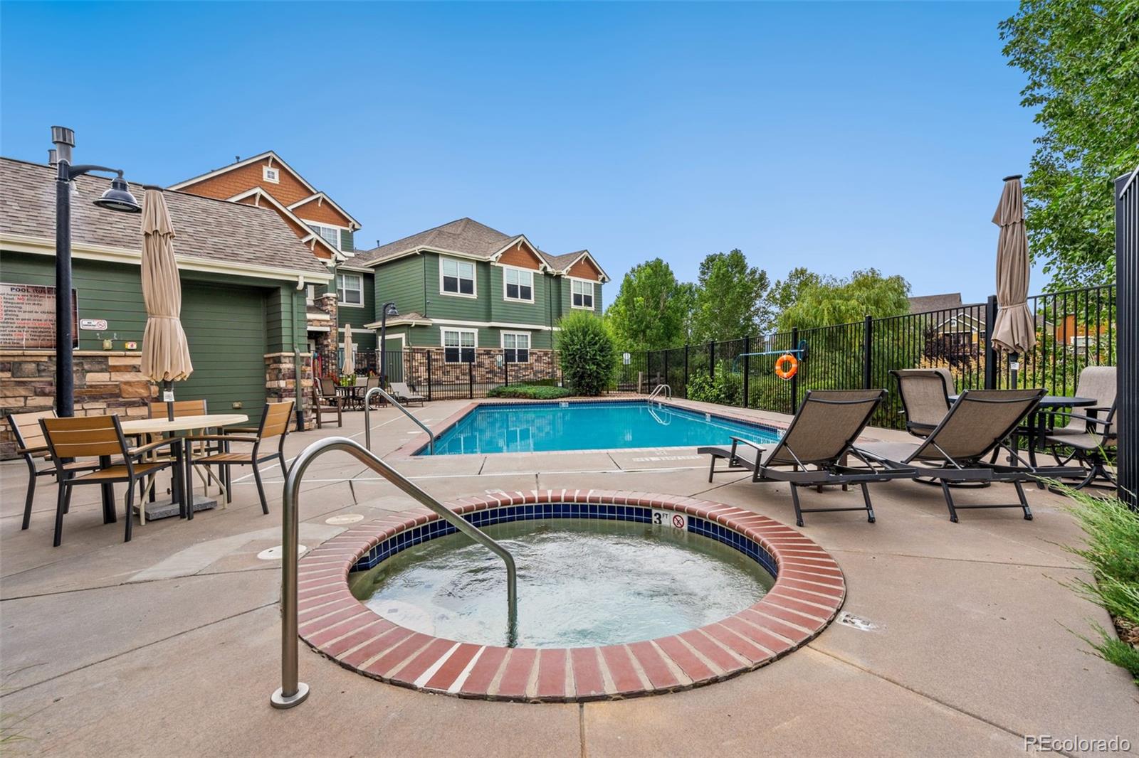 7140 Simms Street, Unit 102 Arvada, CO 80004 - Photo 25 of 34 a view of a house with swimming pool and sitting area