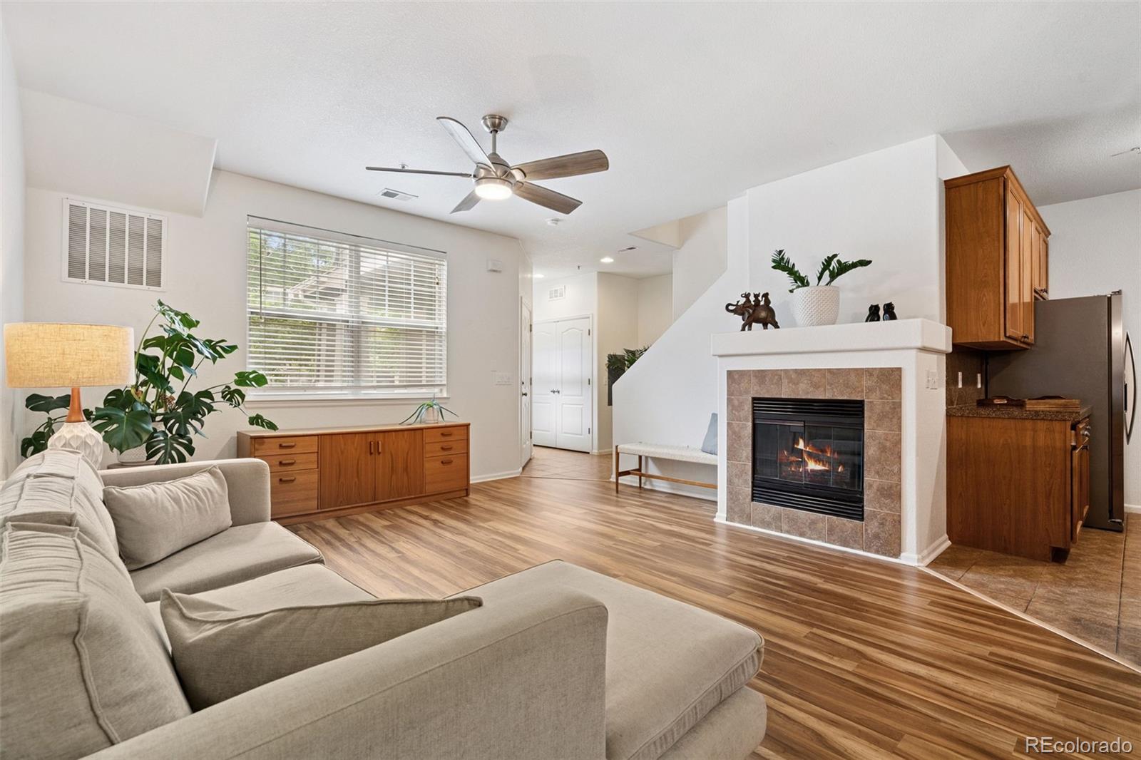 7140 Simms Street, Unit 102 Arvada, CO 80004 - Photo 4 of 34 a living room with furniture and a fireplace