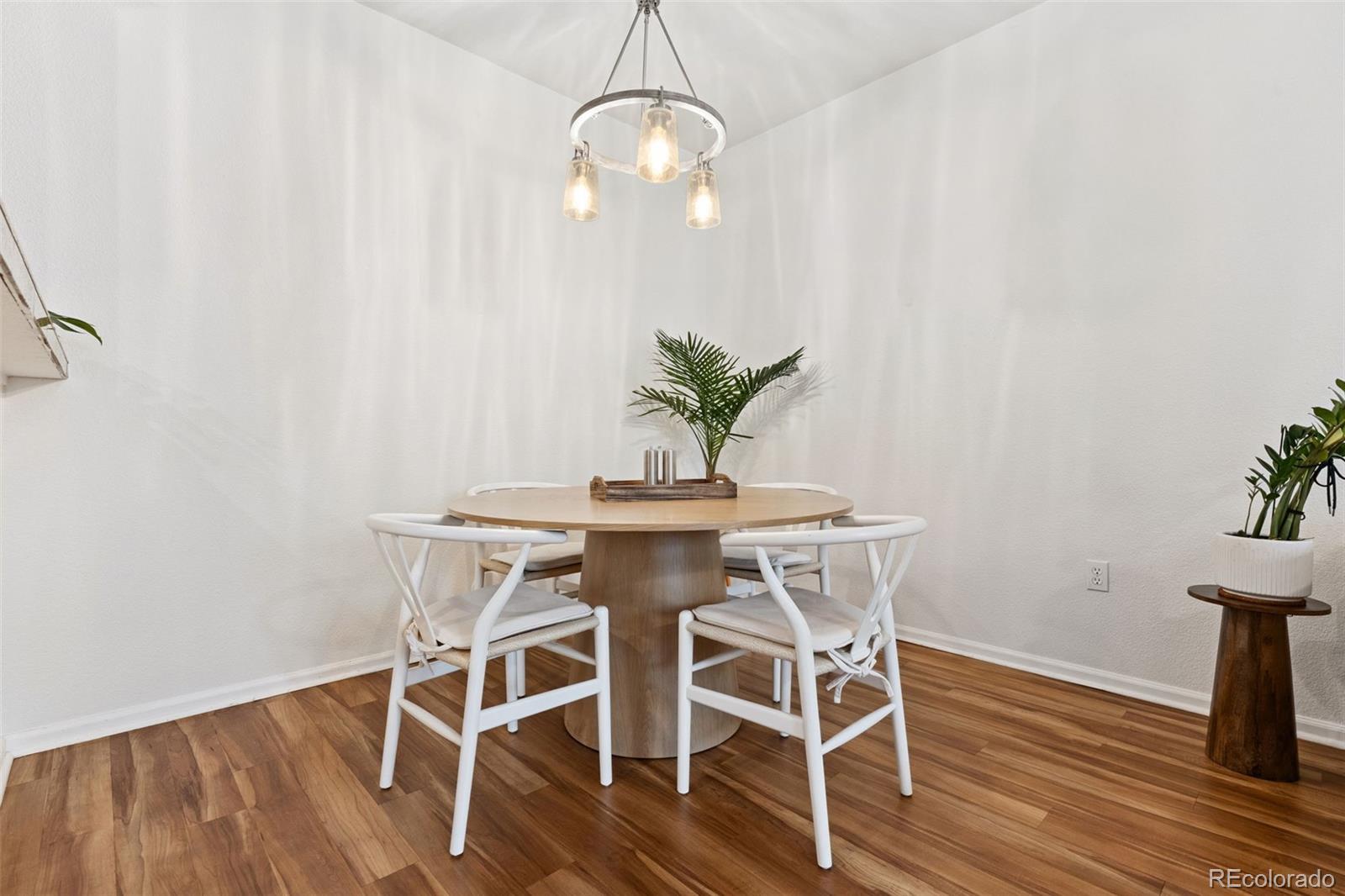 7140 Simms Street, Unit 102 Arvada, CO 80004 - Photo 7 of 34 a view of a dining room with furniture and wooden floor