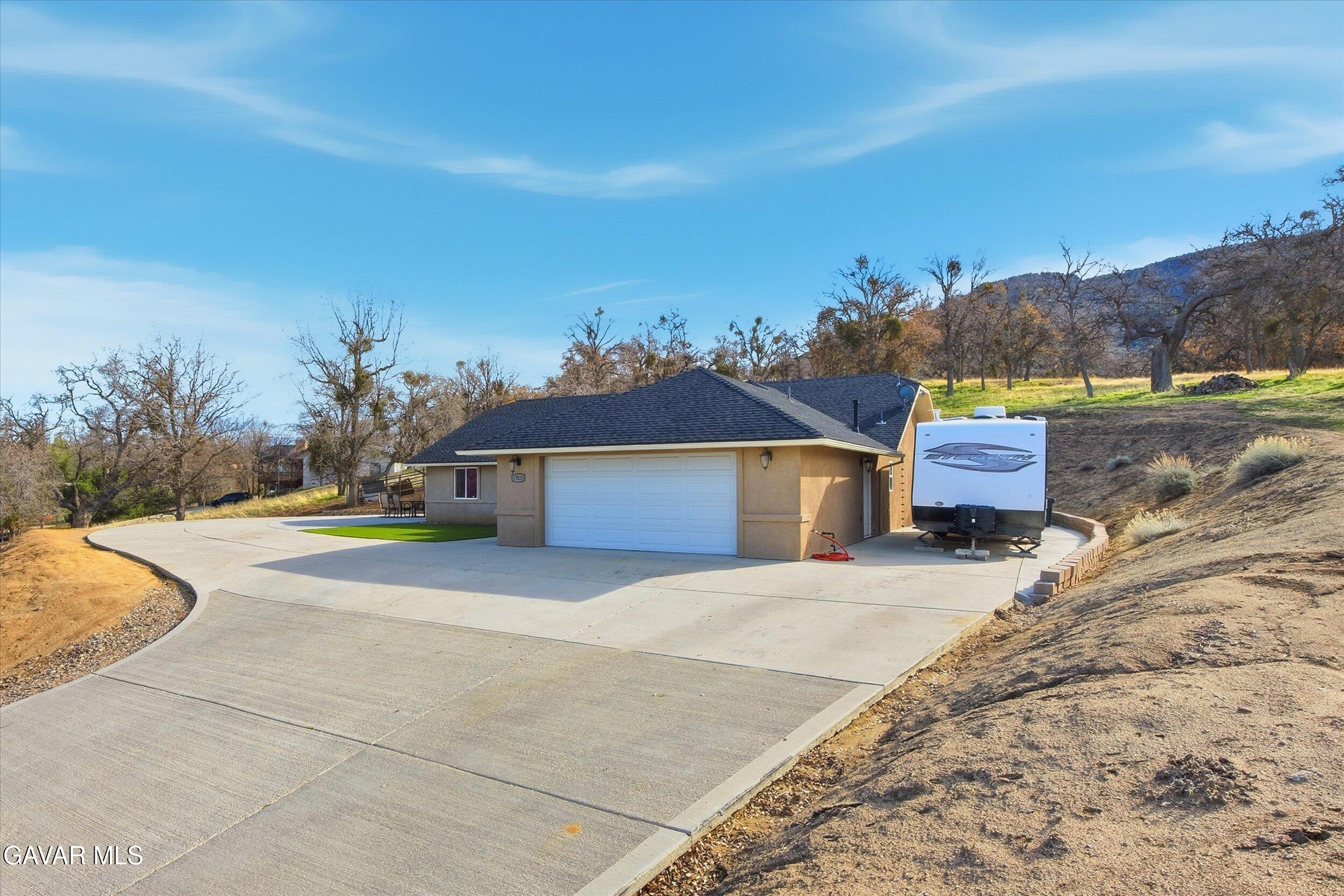 17820 Bold Venture Drive Tehachapi, CA 93561 - Photo 16 of 50 a front view of a house with a yard and garage