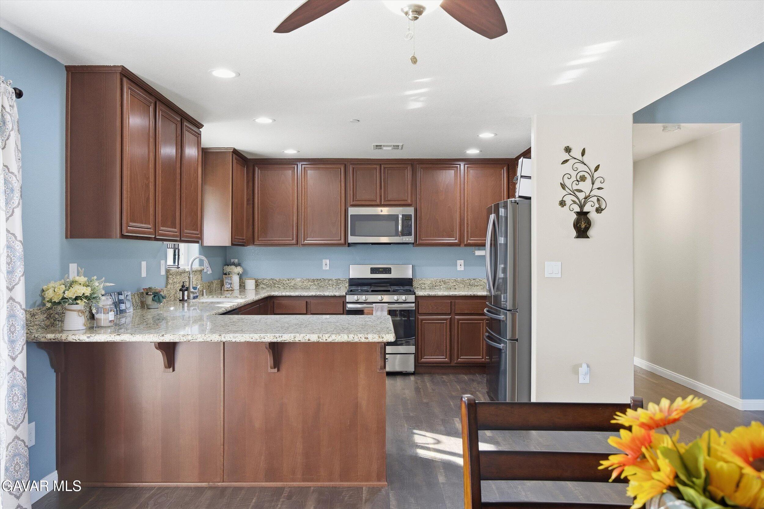 17820 Bold Venture Drive Tehachapi, CA 93561 - Photo 27 of 50 a kitchen with stainless steel appliances granite countertop a refrigerator sink and stove