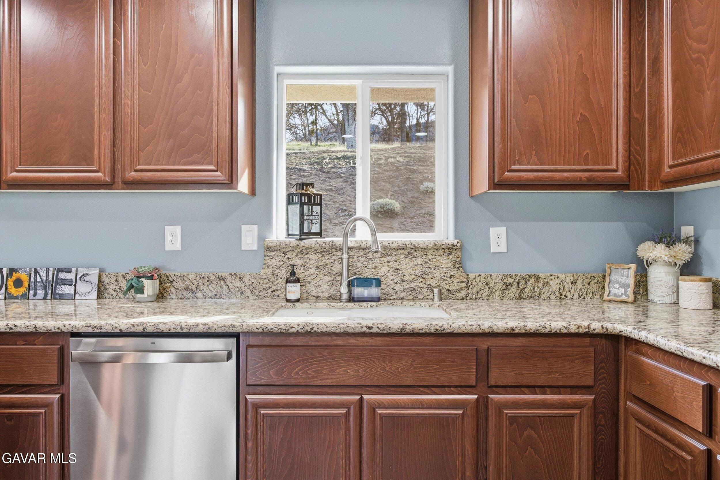 17820 Bold Venture Drive Tehachapi, CA 93561 - Photo 29 of 50 a kitchen with granite countertop cabinets sink and window