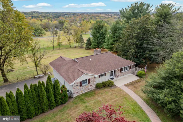 an aerial view of a house with a yard