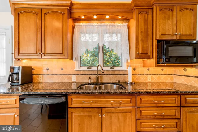 a bathroom with a sink a toilet and a large mirror