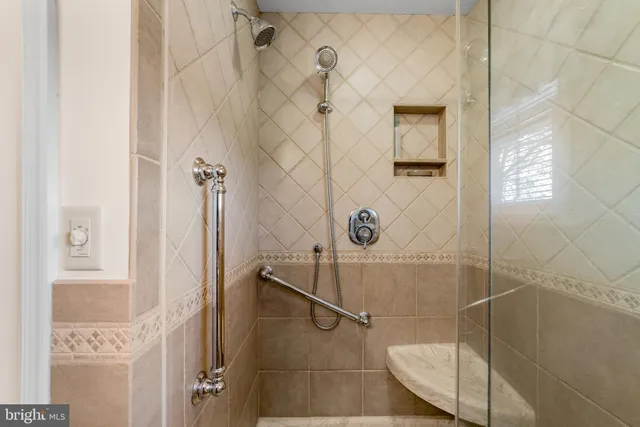 a kitchen with granite countertop a refrigerator and wooden cabinets