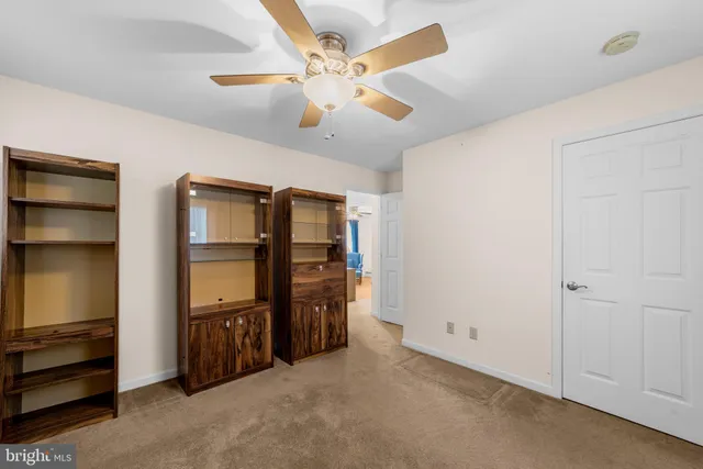 a view of a kitchen with furniture and stainless steel appliances
