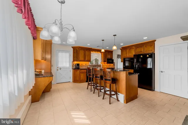 a kitchen with stainless steel appliances granite countertop a refrigerator and a stove