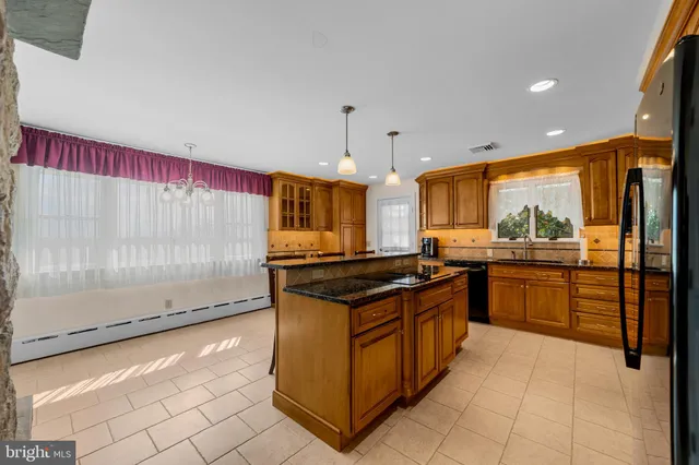 a kitchen with stainless steel appliances granite countertop a sink and cabinets