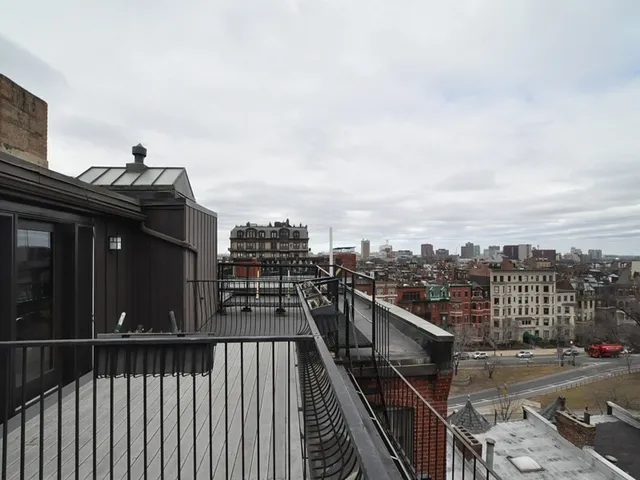 a view of balcony with wooden floor