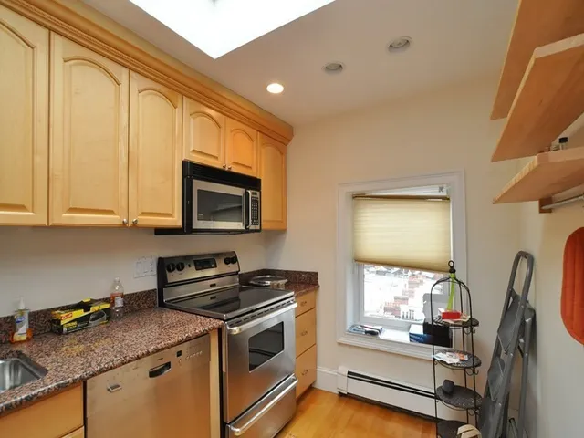 a kitchen with stainless steel appliances granite countertop a stove and a microwave