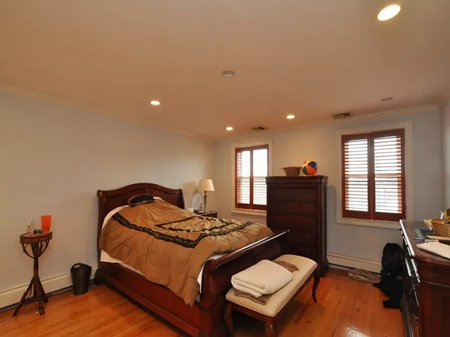 a bedroom with a bed and a workspace