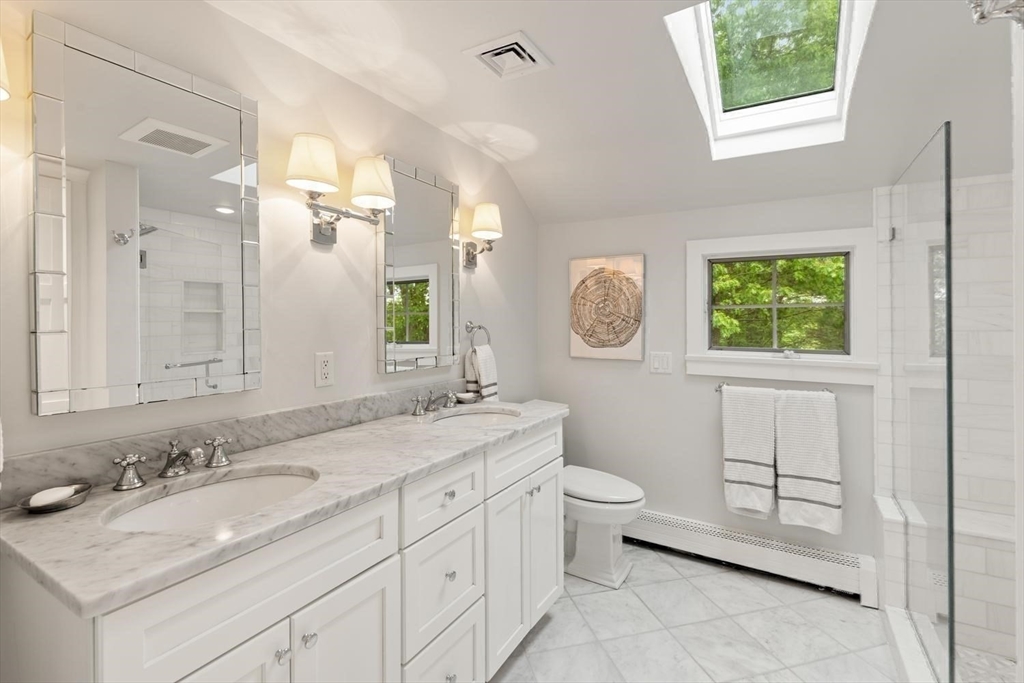 105 Thornberry Road Winchester, MA 01890 - Photo 20 of 35 a bathroom with a double vanity sink a toilet and a mirror