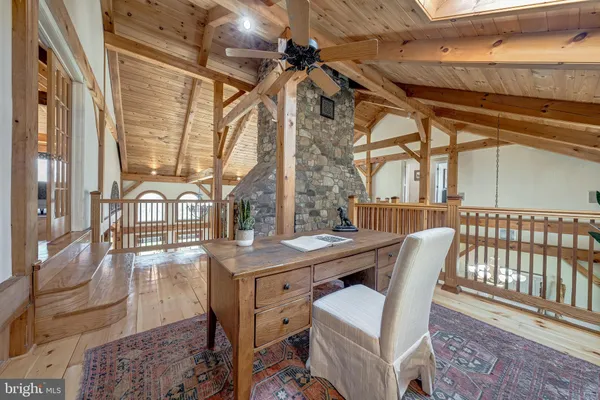 a bedroom with a bed a table and chair