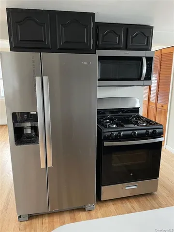 a kitchen with granite countertop stainless steel appliances and wooden cabinets