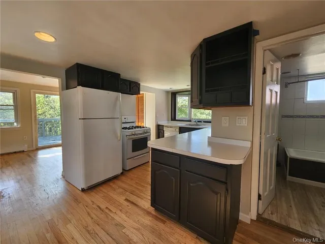 a kitchen with a refrigerator sink and microwave