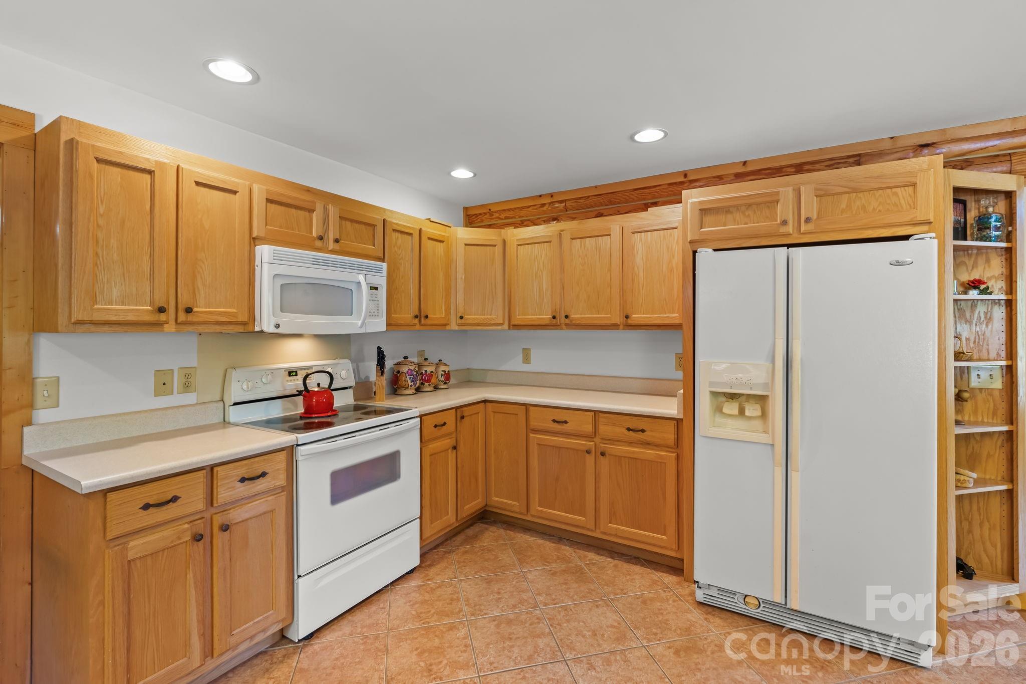 3341 Peniel Road Tryon, NC 28782 - Photo 15 of 48 a kitchen with stainless steel appliances granite countertop a refrigerator sink and cabinets