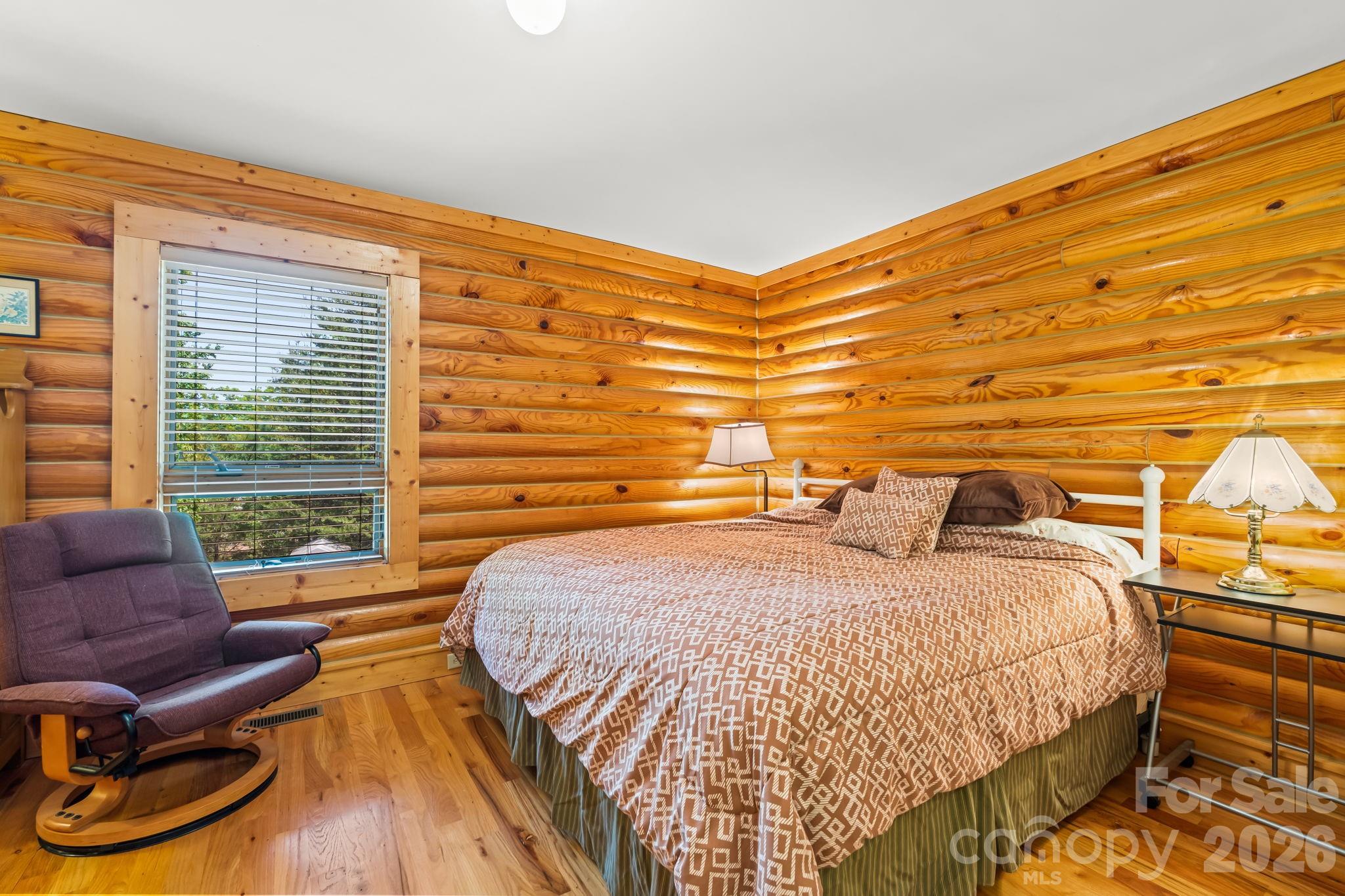 3341 Peniel Road Tryon, NC 28782 - Photo 25 of 48 a bedroom with a bed and wooden floor