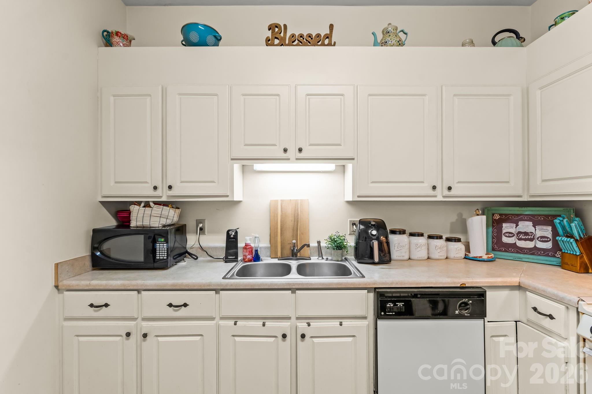 3341 Peniel Road Tryon, NC 28782 - Photo 36 of 48 a kitchen with white cabinets and appliances